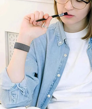 Woman with glasses holding a makeup brush alongside AIFIT COLMI smartwatch with AMOLED display